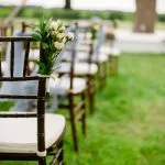 Looking down the aisle towards the pecan tree at a wedding
