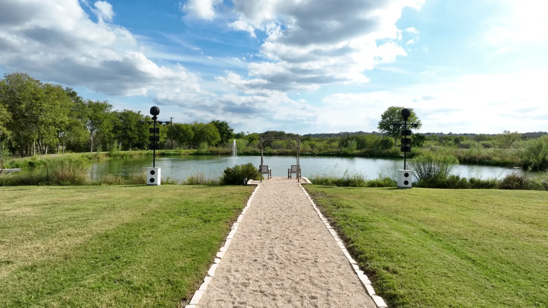 A winding path leads to the pond and open garden lawns
