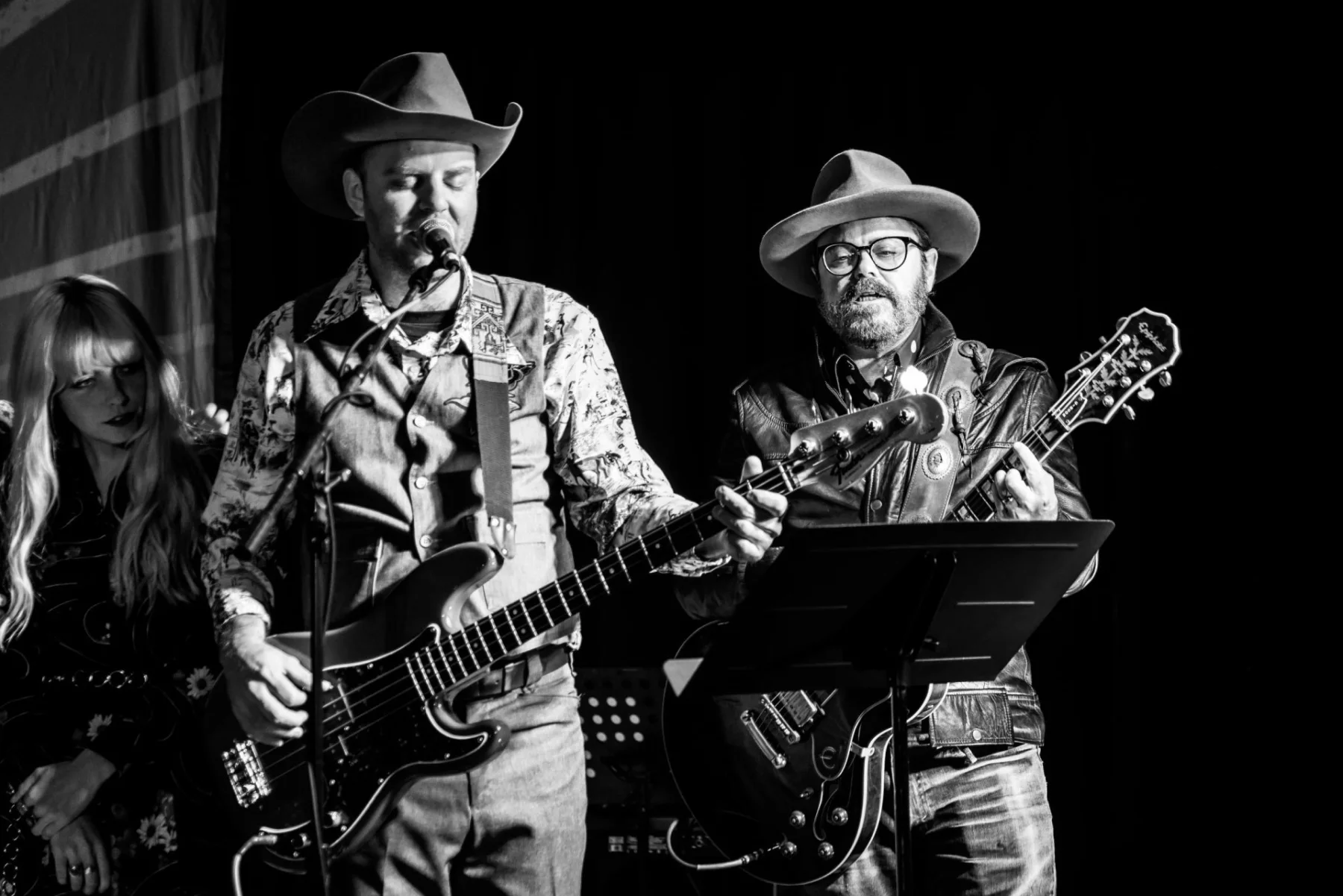 Musicians perform together on stage at Luna Gardens